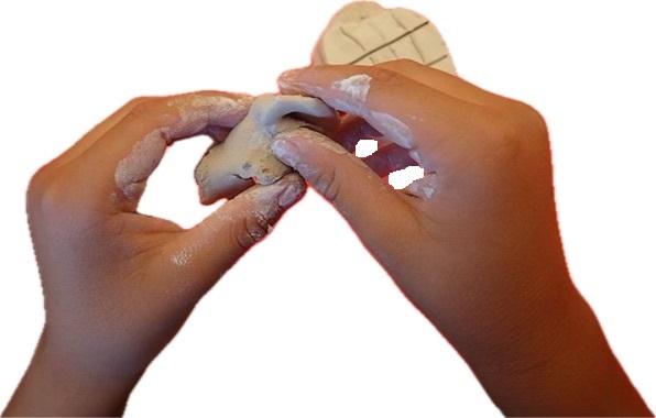 hands shaping clay